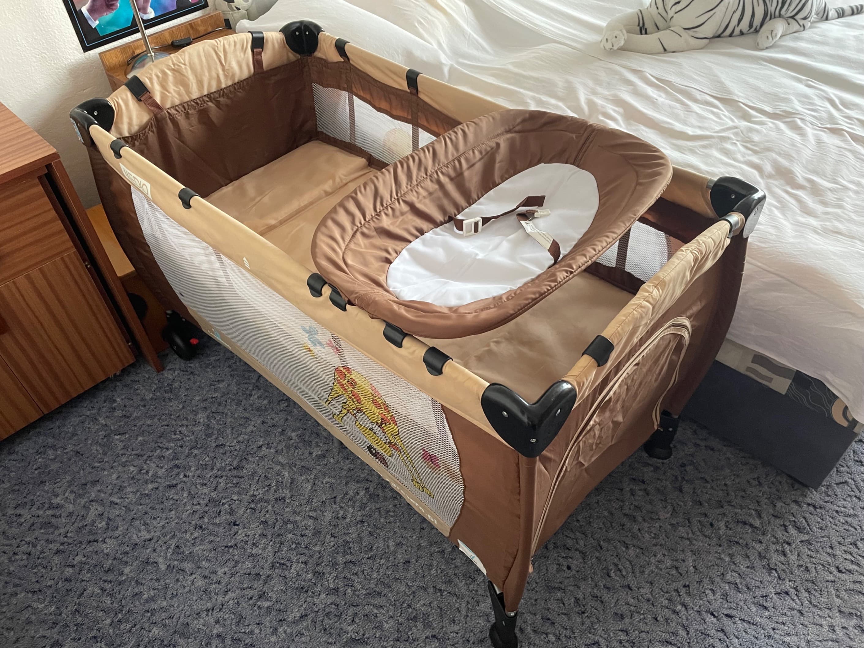 Two level travel cot with changing table