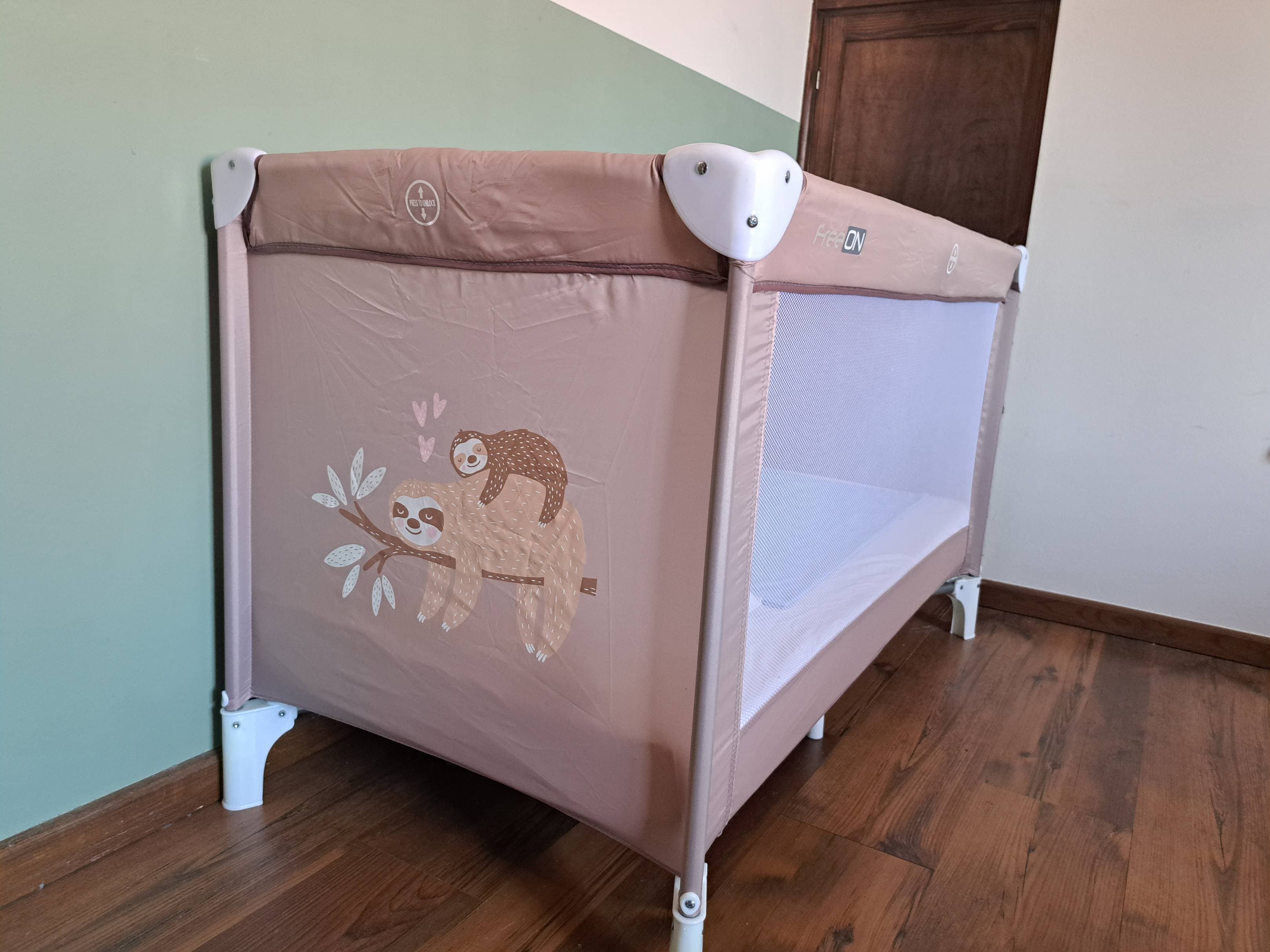 Travel cot with a mattress, pillow and bedding